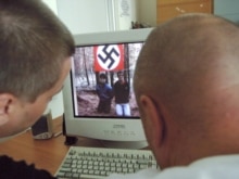 Russia -- The web video shows the victims kneeling in front of a Nazi flag, 14Aug2007