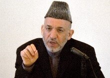 Afghanistan -- President Hamid Karzai (L) speaks during a conference with provincial governors at the Presidential Palace in Kabul, 24 Jan. 2006