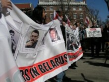 U.S. -- Demonstrators carrying banners outside the Belarusian Embassy in Washington. The banner read: 