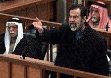 Iraq -- Saddam Hussein gestures in court inside the Green Zone in Baghdad, 13 Feb. 2006