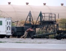 Uzbekistan/U.S. – Staff Sergeant Brian Fentress moves a maintenance stand at Karshi-Khanabad Air Base, undated