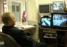 Russia -- television, security guard watches Putin on TV
