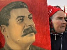 Russia -  A woman carries the portrait of Josef Stalin during the pro-Communist demonstration in Moscow, 01May2007