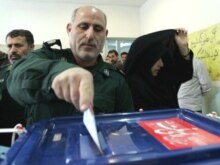 Iran -- A Revolutionary Guard casts his ballot at a polling station in Tehran, 14Mar2008