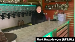 Olena Kolomoyets tends bar in Kyiv.