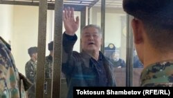 Politician Bektur Asanov waves at the city court in Bishkek in November 2022.