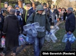 People wait in line for drinking water in Kyiv during a recent outage.