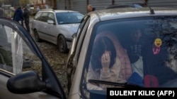 A Ukrainian woman sits in a car in Zaporizhzya with her family after they managed to flee from the Russian-occupied territory of Kherson on November 5.