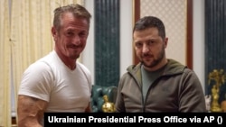 Ukrainian President Volodymyr Zelenskiy (right) poses with U.S. actor Sean Penn after receiving the latter's Oscar statuette and handing him the Order of Merit, third degree, during their meeting in Kyiv on November 8.