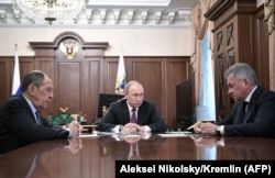 Russian President Vladimir Putin (center) in Moscow with Foreign Minister Sergei Lavrov (left) and Defense Minister Sergei Shoigu. (file photo)