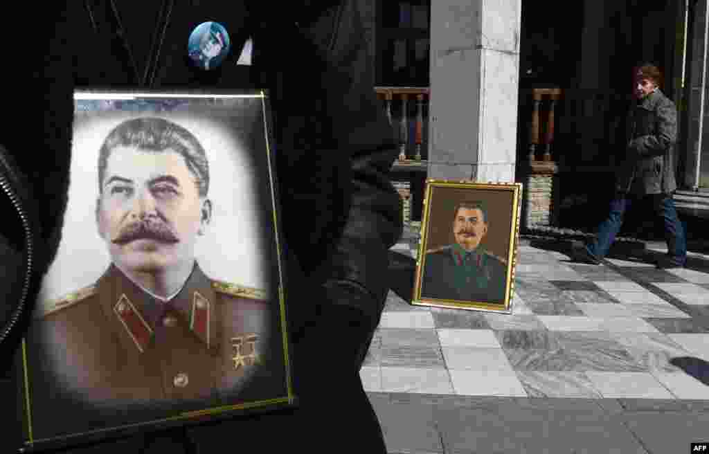 Portraits of Soviet dictator Josef Stalin outside a museum in his native town of Gori, some 80 kilometers outside Tbilisi, on the 64th anniversary of his death. While historians blame Stalin for the deaths of millions in purges, prison camps, and forced collectivization, many in Russia still praise him for leading the Soviet Union to victory over Nazi Germany in World War II. (AFP/Vano Shlamov)