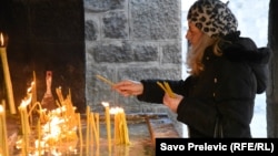 A member of the Serbian Orthodox Church attends a service during Orthodox Christmas Eve celebrations in Cetinje, Montenegro, January 6. The Montenegrin Orthodox Church also held an event in the town on the same day just a few hundred meters away.