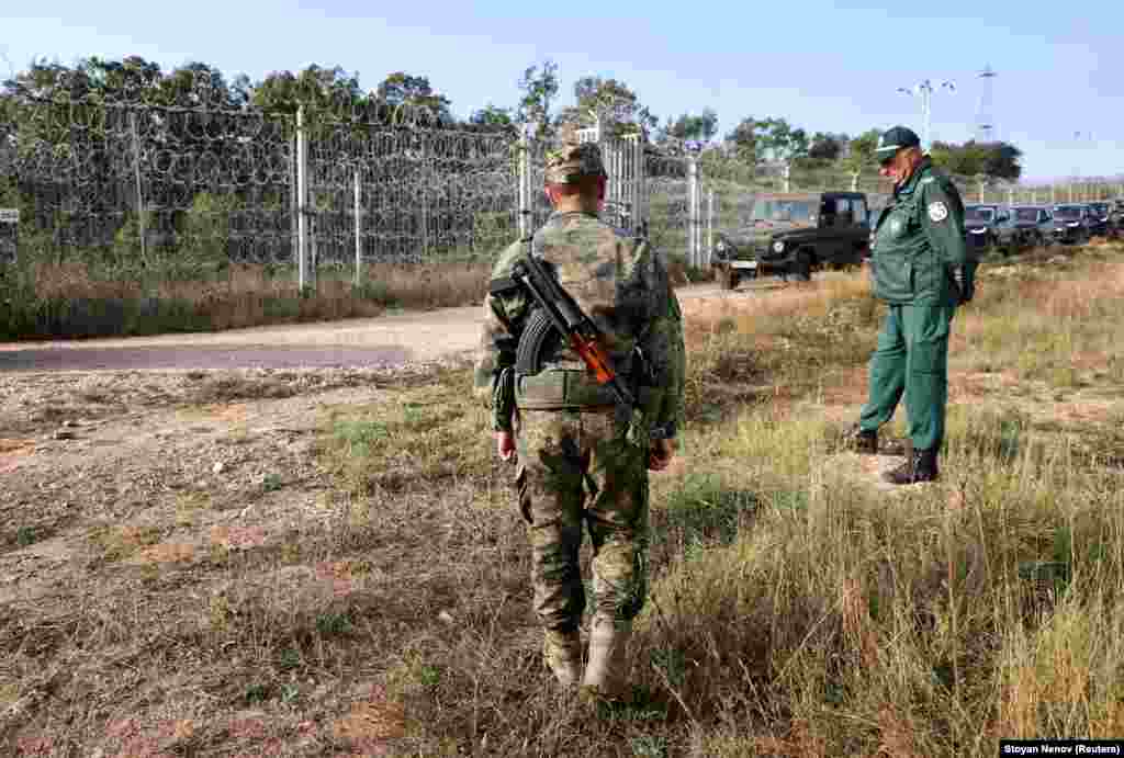 Bulgarian border police are photographed on September 2 near a fence on their country&rsquo;s border with Turkey. Construction of this border barrier began in 2014 as what became known as the migrant crisis was just beginning. Turkey&rsquo;s ambassador to Bulgaria at the time criticized the fence and what he called the &quot;political message&quot; it sent. &nbsp;