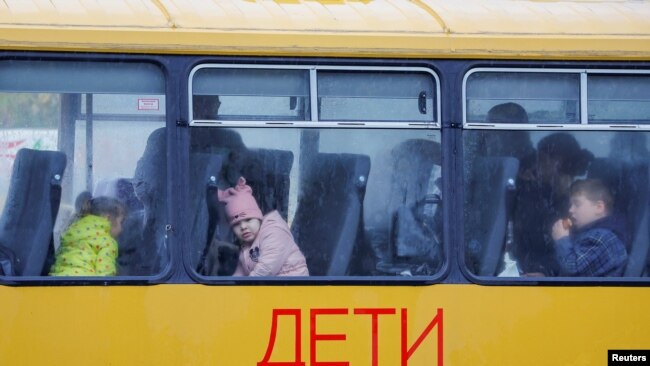 Діти під час окупації Херсона, чекають в автобусі, який прямує до Криму, 23 жовтня 2022 року