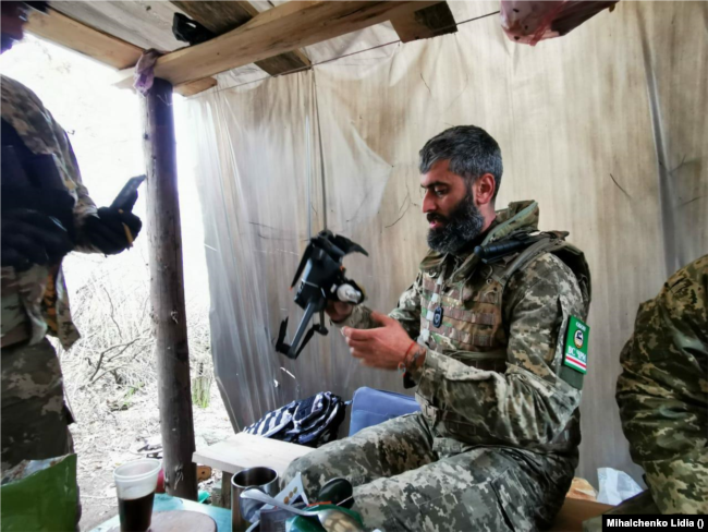 Georgy Akhalaia, a fighter of the Ichkerian battalion fighting on the side of Ukraine, prepares a drone for flight.