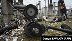 A worker walks past damaged equipment at a high-voltage substation of the operator Ukrenerho after a missile attack in central Ukraine on November 10. 
