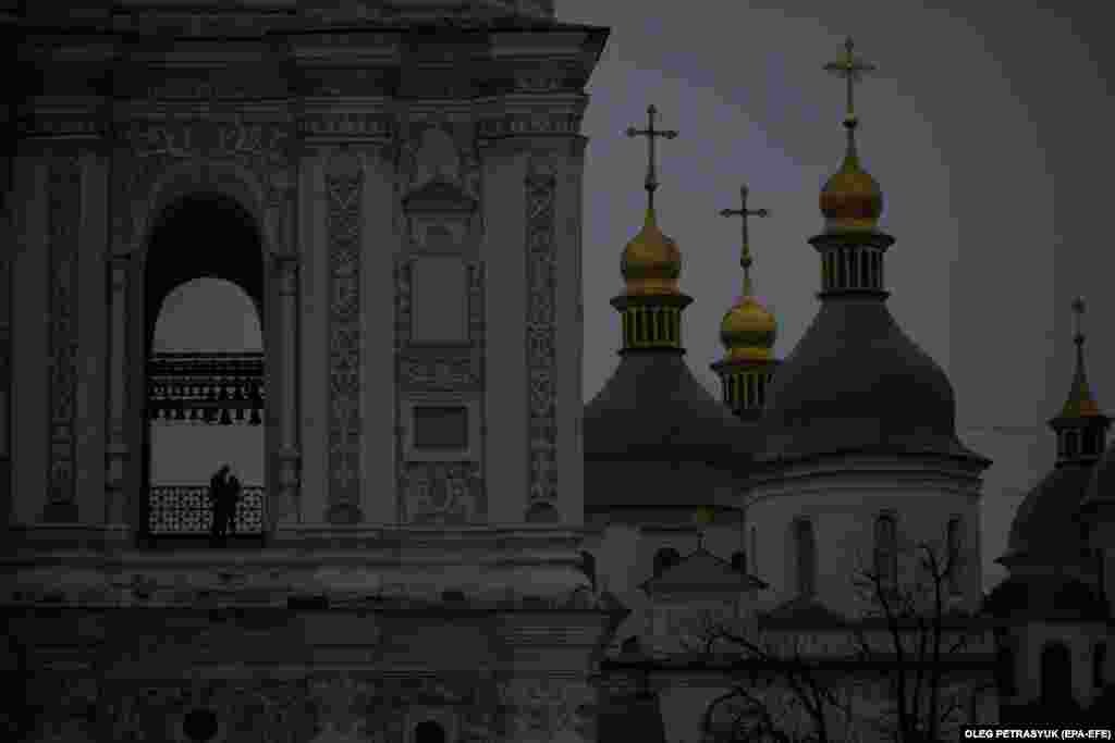 People stand in the bell tower of St. Sofia Cathedral as power cuts continue in Kyiv on November 10.