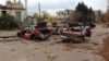 Damaged cars and buildings in Velyka Oleksandrivka.
