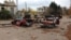 Damaged cars and buildings in Velyka Oleksandrivka.