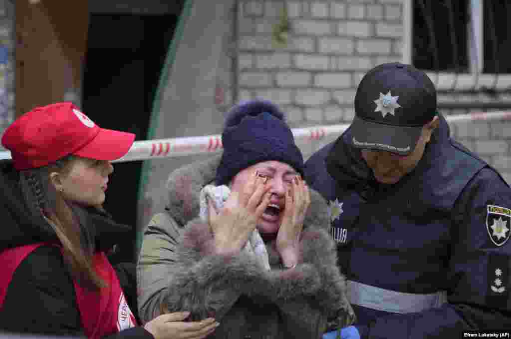 A woman is comforted at the scene of overnight Russian shelling of a residential district in Mykolayiv, Ukraine, on November 11. Six civilians were killed.