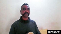 Pakistan has handed out a photo of what it says is a captured Indian pilot.