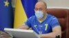 Ukrainian Prime Minister Denys Shmyhal wears the No. 7 jersey of team captain Andriy Yarmolenko during a government meeting in Kyiv on June 30.