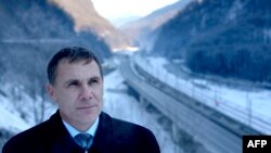 Environmental Watch activist Yevgeny Vitishko stands in front of the new road between Adler and Krasnaya Polyana in the Black Sea resort of Sochi. 