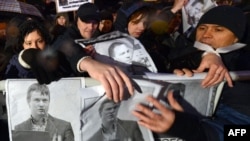 Russian opposition activists hold posters bearing portraits of a jailed opposition activist Leonid Razvozzhayev during a rally in central Moscow last month.