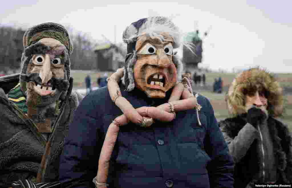 Masked revellers during Maslenitsa celebrations in Kyiv on February 26. As well as the food and samovars, Maslenitsa features some very rowdy events, most infamously mass fist-fights.