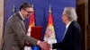 Austrian author Peter Handke, right, receives the Order of the Serbia from President of Serbia Aleksandar Vucic during the ceremony in Belgrade, May 9, 2021. 