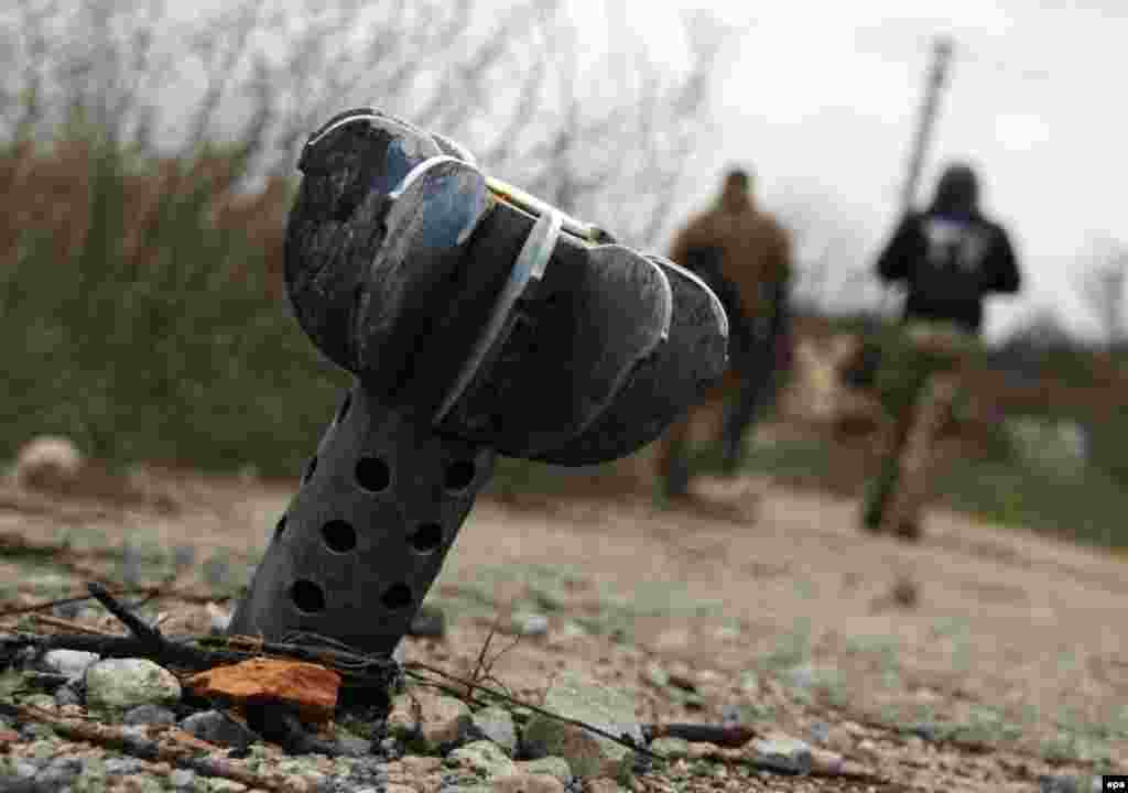 Një predhë e pashpërthyer është parë në një rrugë, pas granatimeve në fshatin Shyrokyne, jo shumë larg nga Mariupoli, në lindje të Ukrainës.