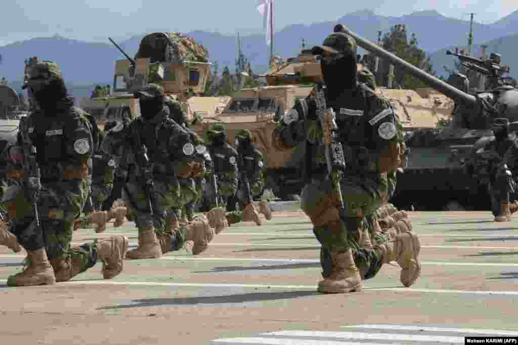 Newly recruited personnel joining Taliban security forces demonstrate their skills during a graduation ceremony in Herat.