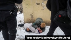 A serviceman treats a woman wounded by a Russian missile strike in the eastern Ukrainian city of Kramatorsk, on February 2.