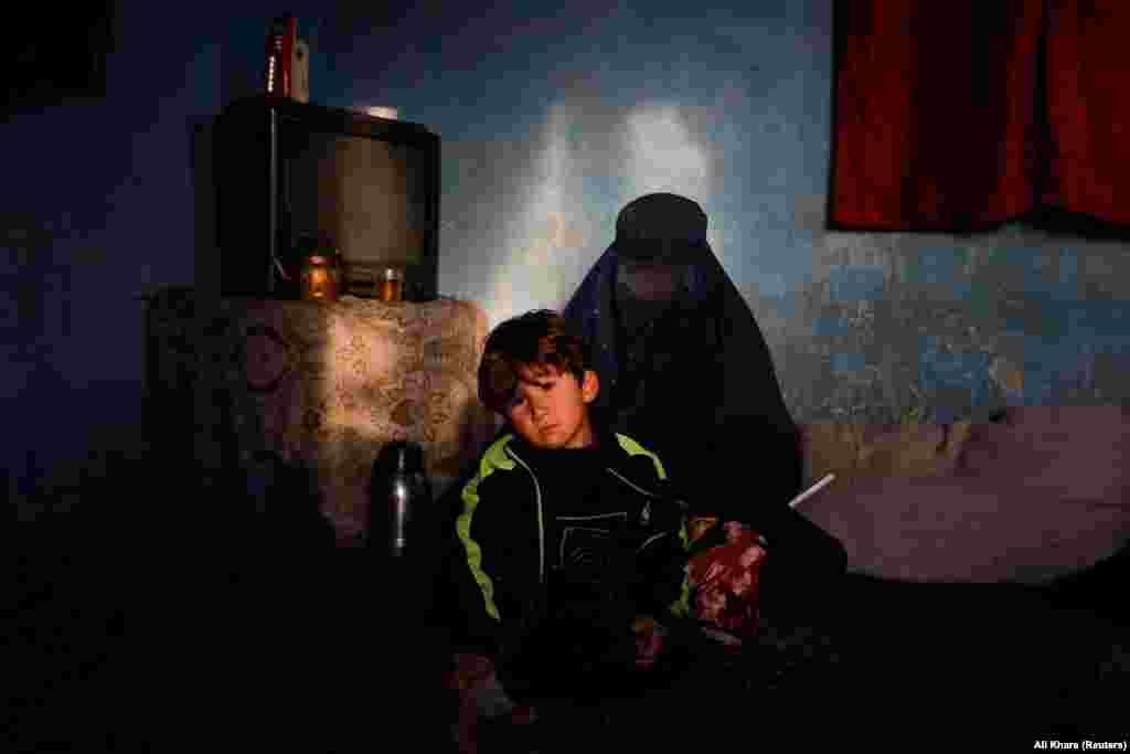 Shamila, with another of her sons, recalls the bitterly cold night she clutched her baby and covered herself in a quilt. Around midnight, she awoke to find his face cold.
