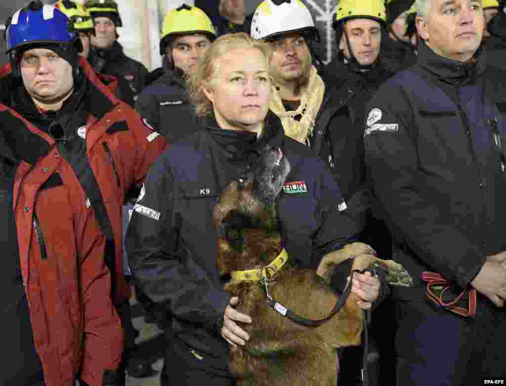 Hungarian rescuers -- part of a 50-member team being sent to Turkey -- listen to an address before flying out of Budapest on February 6.&nbsp;