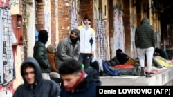 Migrants, mostly from Afghanistan, wrapped in jackets and blankets because of the cold, wait on a platform at the railway station in Rijeka, on the Adriatic coast in western Croatia in February.