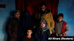 The devastated Mohammad family poses for a photo in their home in Kabul on January 30. The mother, Shamila, doesn&#39;t have a photo of her baby Amrullah, who died in her arms, but she remembers his face perfectly. &quot;He had a white and bright face, big eyes, a small nose, and black hair,&quot; she said.