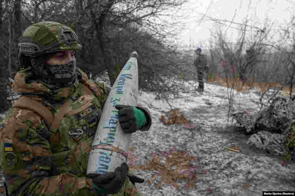 A member of the 3rd Separate Assault Brigade (Azov Unit) of the Armed Forces of Ukraine prepares to fire a 152-mm howitzer shell with an inscription &quot;From Ihor [in revenge] for Mariupol&quot; amid Russia&#39;s attack on Ukraine, near Bahmut.