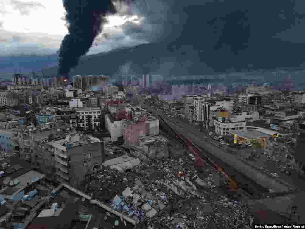 Rescuers search rubble as fires burn in Iskenderun, a coastal city in southern Turkey, on February 7.&nbsp; A quake measuring 7.8 on the Richter scale hit southern Turkey and northwest Syria early in the morning of February 6. At least 7,800 people are reported to have died in the quake, and thousands more remain trapped in rubble from buildings that collapsed. The disaster has sparked a massive international response, with teams flying in from around the world to help with rescue efforts.&nbsp;