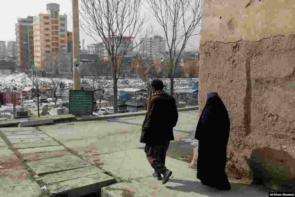 The parents walk to the cemetery to visit Amrullah&#39;s grave. Without money to host funeral guests, they quietly buried their baby without informing their family. &nbsp;