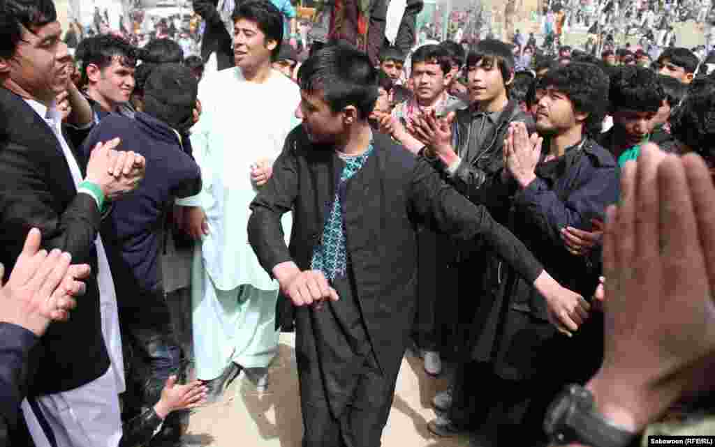 Kabul men dance with each other as part of the Norouz celebrations. 