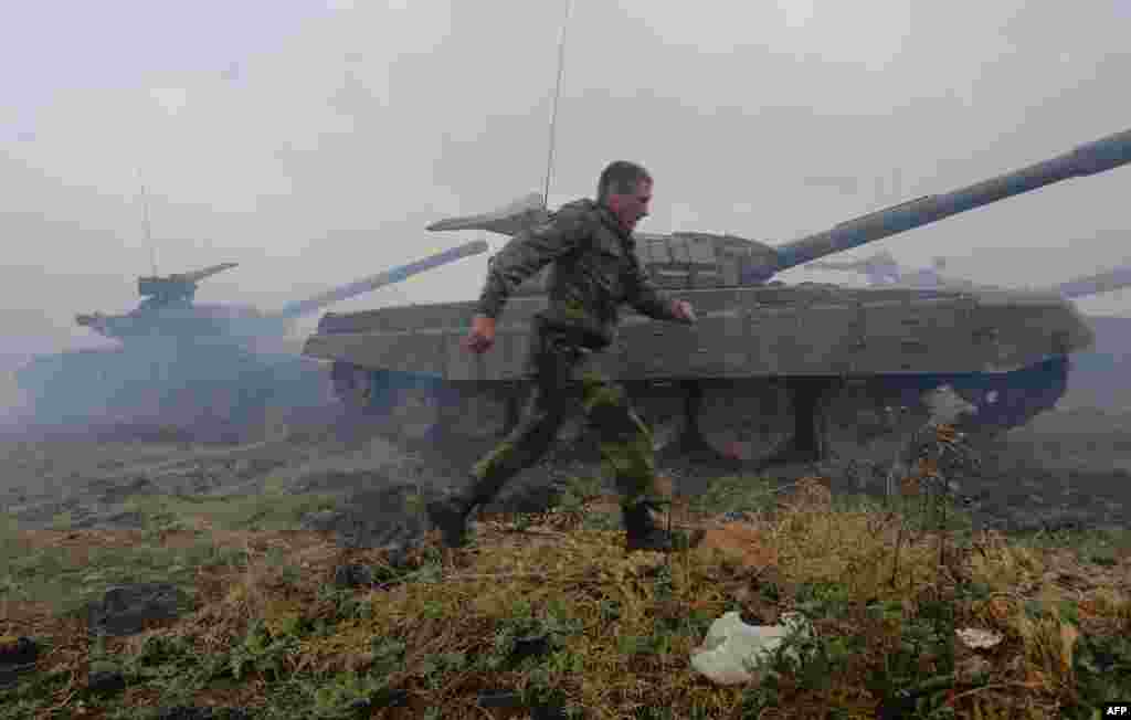 Pro-Russian separatists take part in a military competition between tank units near the town of Torez in the Donetsk region of Ukraine. (AFP/Aleksei Filippov)