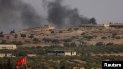 Smoke rises from the Syrian border town of Jarablus, where militant positions were attacked by Turkish forces on August 24. 