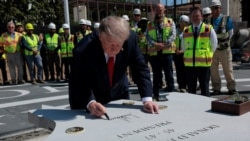 US President Donald Trump signs a stone that will be inserted into the helipad that is being constructed on the South Lawn at the White House in Washington, D.C., US, on August 19, 2026.