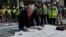 US President Donald Trump signs a stone that will be inserted into the helipad that is being constructed on the South Lawn at the White House in Washington, D.C., US, on August 19, 2026.