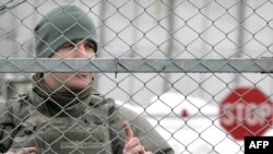 Kyrgyzstan -- A US soldier guards the main access checkpoint to the US Manas air base, 04Feb2009