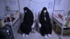 Women sit with their babies receiving treatment for malnutrition at a Doctors Without Borders nutrition center in the western Afghan city of Herat.