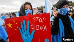 Ethnic Uyghur demonstrators take part in a protest against China in Istanbul on October 1.