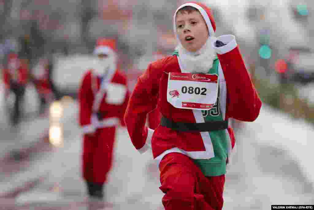 Participants wearing Santa Claus costumes take part in a charity run in Pristina, Kosovo, on December 12.