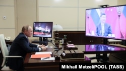 Putin meets with Xi via video link from his residence outside Moscow on December 15.